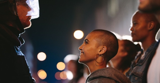 young woman smiling at a police officer
